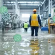 Employés marchant dans une usine inondée après une tempête ou événement climatique extrême