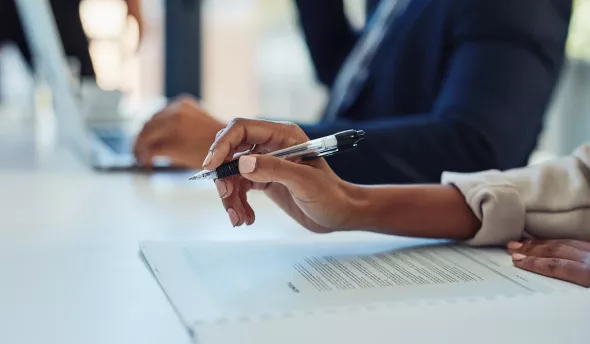 femme et homme devant ordinateur et papiers