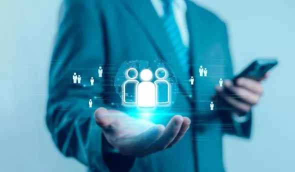 Data analyst RH observant un tableau de bord rempli de graphiques d’absentéisme et de mobilité interne sur un grand écran.