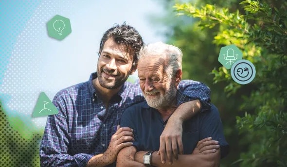 Un fils souriant enlace son père retraité dans un jardin verdoyant