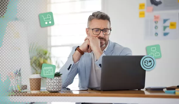Homme mature en costume, l’air sceptique et concentré face à son ordinateur dans un bureau lumineux.