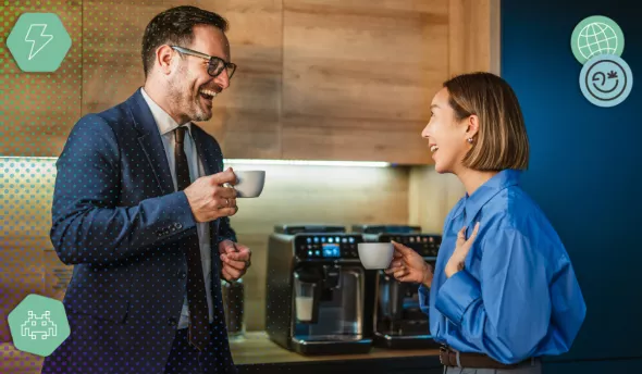 Échanges entre collègues de générations différentes autour d’une machine à café