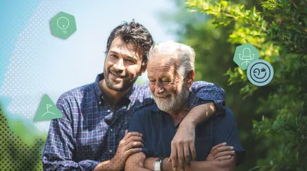 Un fils souriant enlace son père retraité dans un jardin verdoyant