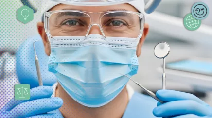 Dentiste portant un masque et des lunettes tenant des outils médicaux