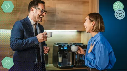 Échanges entre collègues de générations différentes autour d’une machine à café