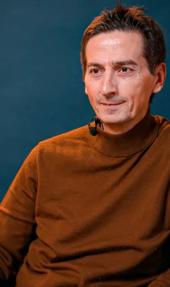 l'intervenant est assis sur un fauteuil et écoute une autre personne